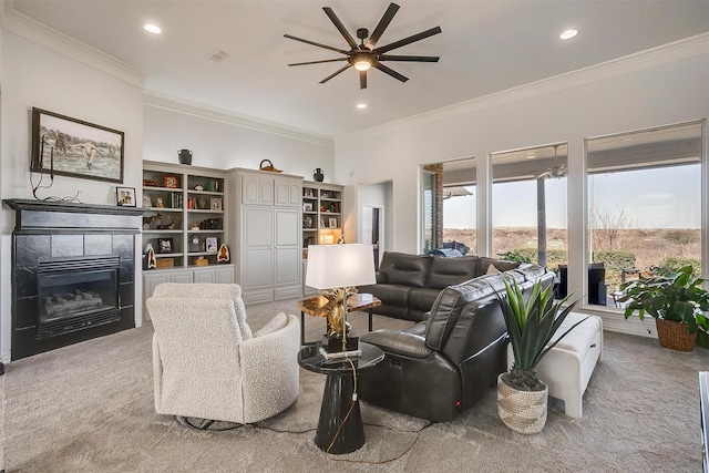 living area with ornamental molding, a tile fireplace, visible vents, and recessed lighting