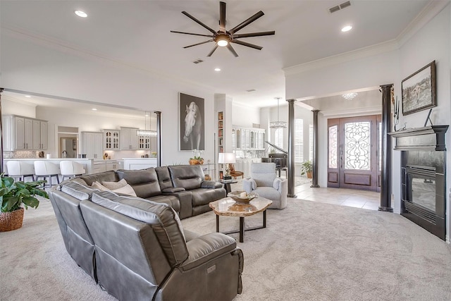 living room featuring light carpet, ornamental molding, light tile patterned floors, and visible vents