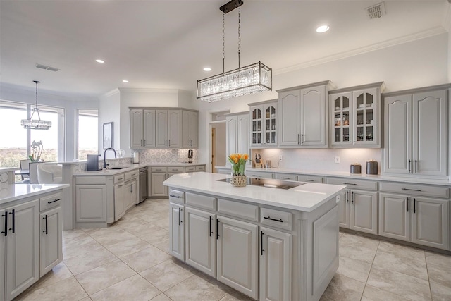 kitchen featuring glass insert cabinets, a center island, visible vents, and gray cabinetry