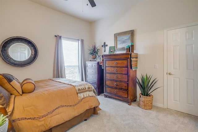 bedroom featuring a ceiling fan and light colored carpet