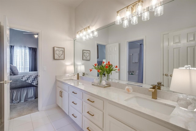 full bath with double vanity, a shower, ensuite bath, tile patterned floors, and a sink