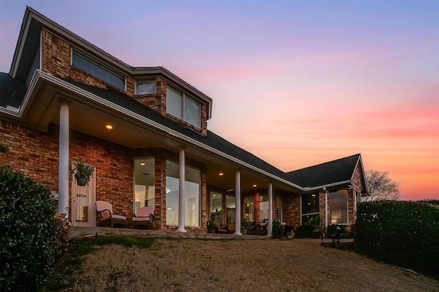 rear view of property with brick siding