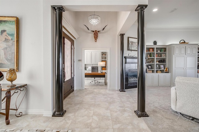 corridor featuring light tile patterned floors, decorative columns, baseboards, and ornamental molding