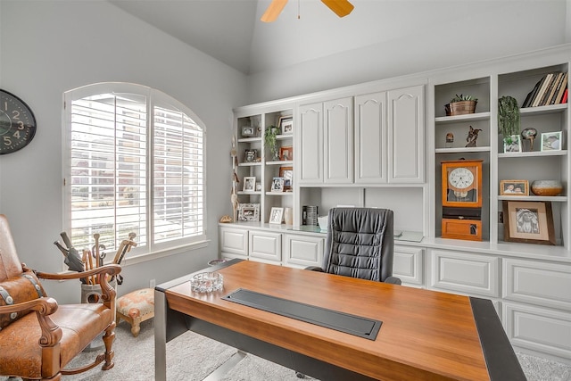 home office with lofted ceiling and a ceiling fan