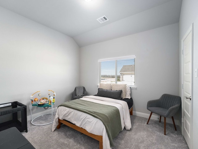 carpeted bedroom with lofted ceiling, visible vents, and baseboards