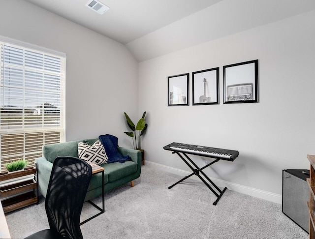 office area featuring carpet floors, visible vents, vaulted ceiling, and baseboards