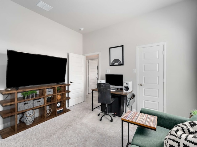 carpeted office space featuring baseboards and visible vents