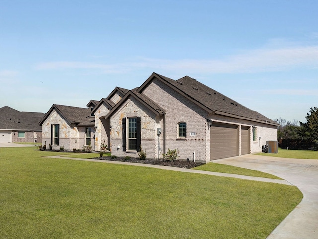 french country style house featuring a garage, driveway, a front lawn, and brick siding