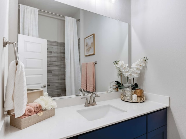 bathroom with curtained shower and vanity