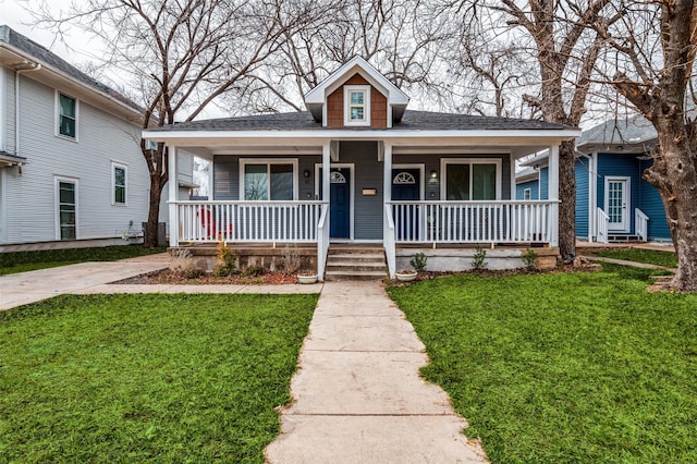 bungalow-style home with a porch and a front lawn