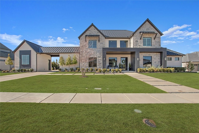 view of front of house with stone siding, a front yard, metal roof, and a standing seam roof