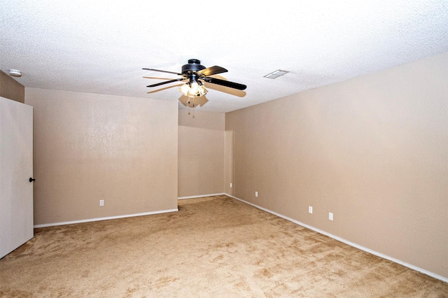 unfurnished room featuring visible vents, a ceiling fan, light carpet, a textured ceiling, and baseboards