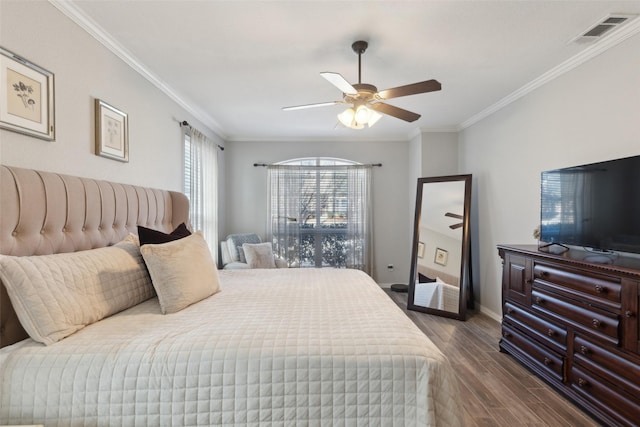 bedroom featuring visible vents, crown molding, baseboards, and wood finished floors