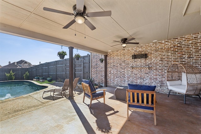 view of patio / terrace featuring a fenced backyard, a fenced in pool, and a ceiling fan