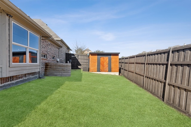 view of yard featuring a fenced backyard, a storage unit, and an outdoor structure