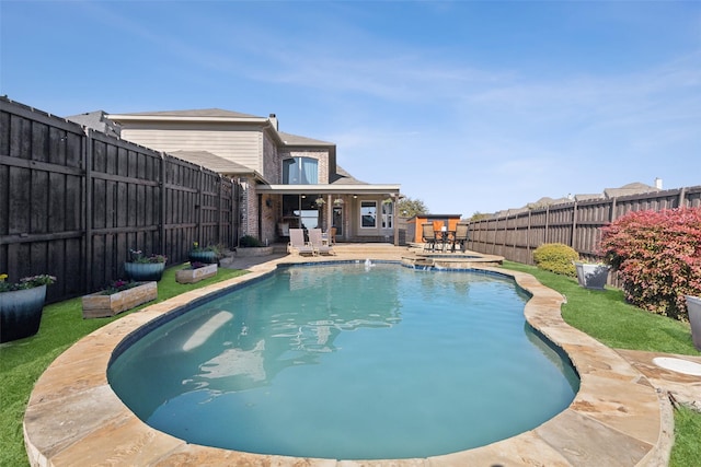 view of pool with a pool with connected hot tub, a fenced backyard, and a patio