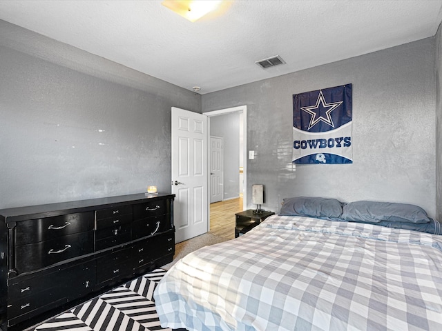 bedroom with visible vents and a textured ceiling