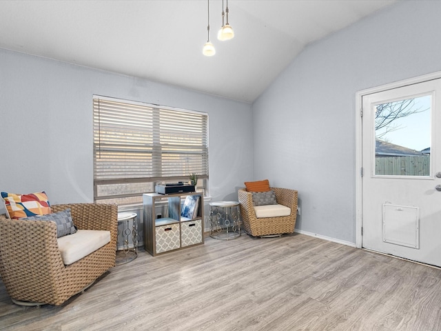 sitting room featuring vaulted ceiling and wood finished floors