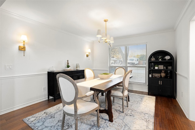 dining area with baseboards, a chandelier, wood finished floors, and ornamental molding