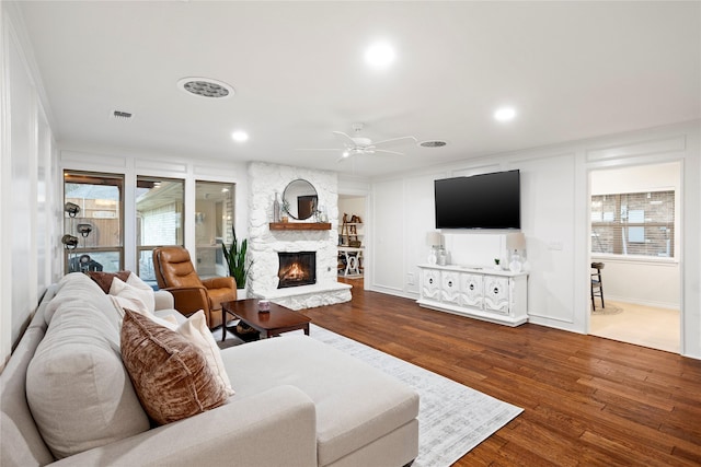 living room with visible vents, ceiling fan, wood finished floors, a fireplace, and recessed lighting