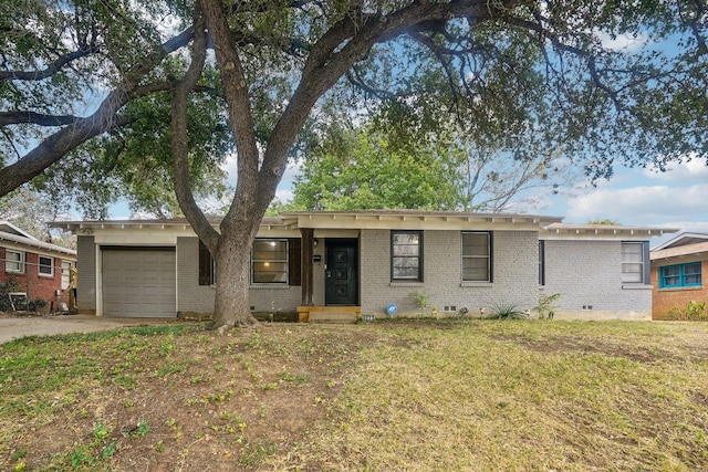 ranch-style home featuring an attached garage, brick siding, driveway, crawl space, and a front lawn