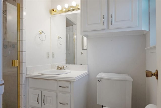 bathroom with a stall shower, vanity, and toilet