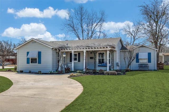 single story home with covered porch, concrete driveway, and a front yard