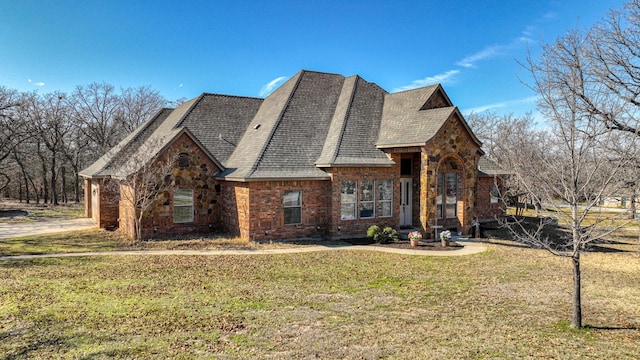 exterior space with brick siding and a yard