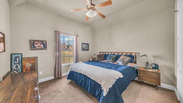 carpeted bedroom with ceiling fan, baseboards, and vaulted ceiling