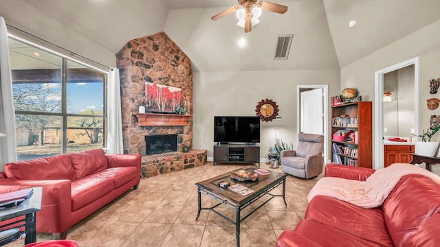 tiled living room featuring high vaulted ceiling, a fireplace, visible vents, and a ceiling fan