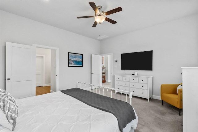 bedroom with a ceiling fan, carpet, and baseboards