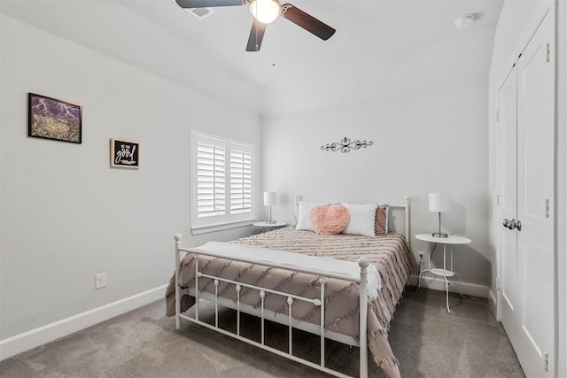 carpeted bedroom featuring ceiling fan, a closet, and baseboards