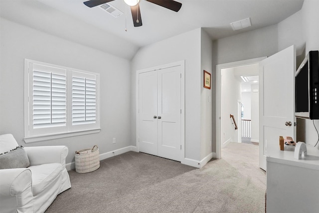 living area featuring carpet floors, an upstairs landing, visible vents, and baseboards