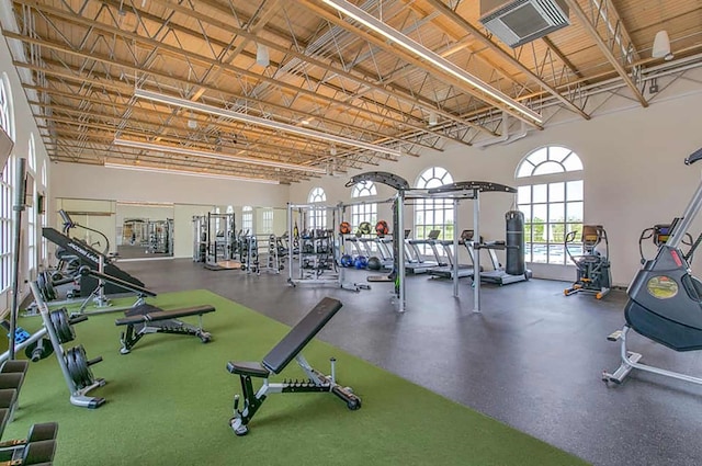 gym with a towering ceiling and visible vents