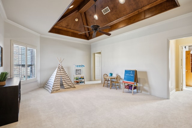 recreation room featuring carpet floors, wood ceiling, a raised ceiling, and crown molding