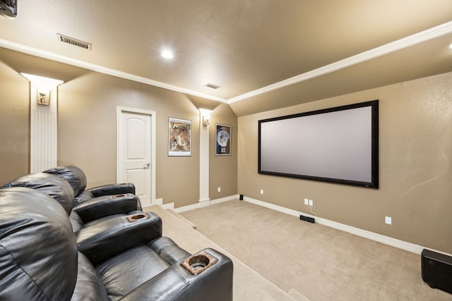 cinema room featuring light colored carpet, visible vents, vaulted ceiling, and baseboards