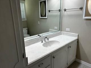 bathroom with vanity and baseboards