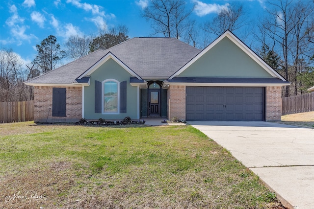 single story home with a front yard, fence, driveway, an attached garage, and brick siding