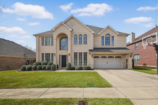 view of front facade with driveway, a shingled roof, an attached garage, a front lawn, and brick siding