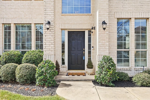 property entrance with brick siding