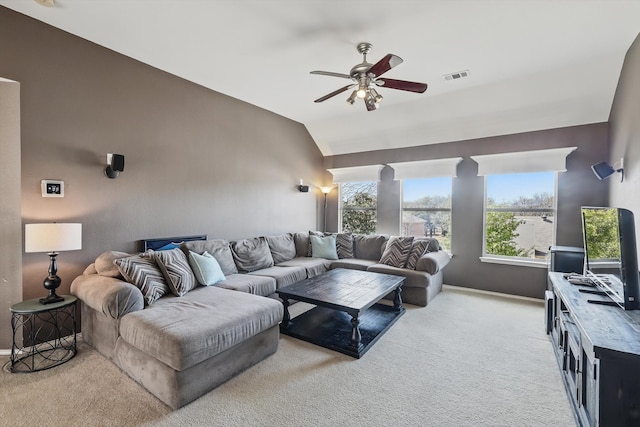 living area featuring light colored carpet, lofted ceiling, visible vents, and ceiling fan