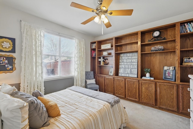 bedroom with a ceiling fan and light colored carpet