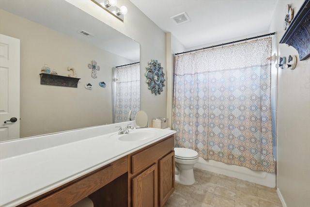 bathroom featuring toilet, vanity, visible vents, and shower / tub combo with curtain