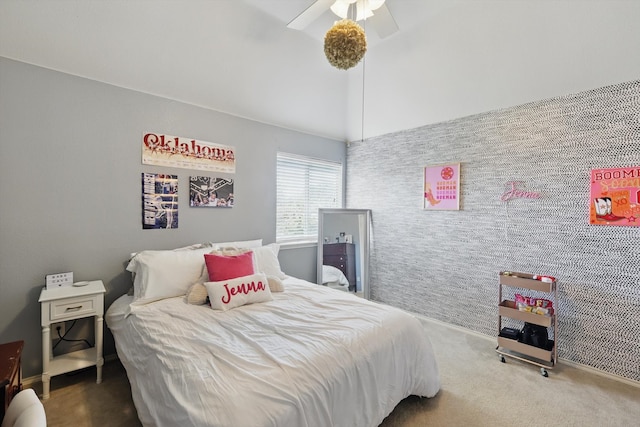 carpeted bedroom with a ceiling fan and vaulted ceiling