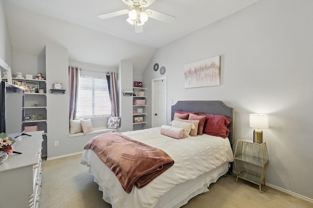 bedroom with light carpet, baseboards, vaulted ceiling, and a ceiling fan