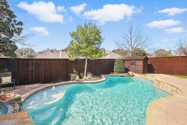 view of swimming pool featuring an outbuilding, a storage unit, a fenced backyard, and a fenced in pool