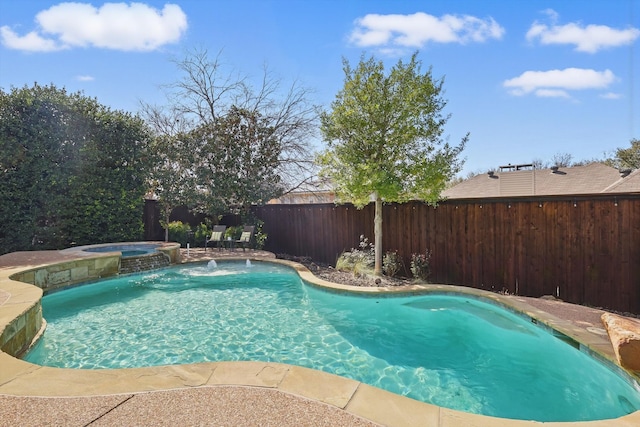 view of pool featuring a fenced backyard and a pool with connected hot tub