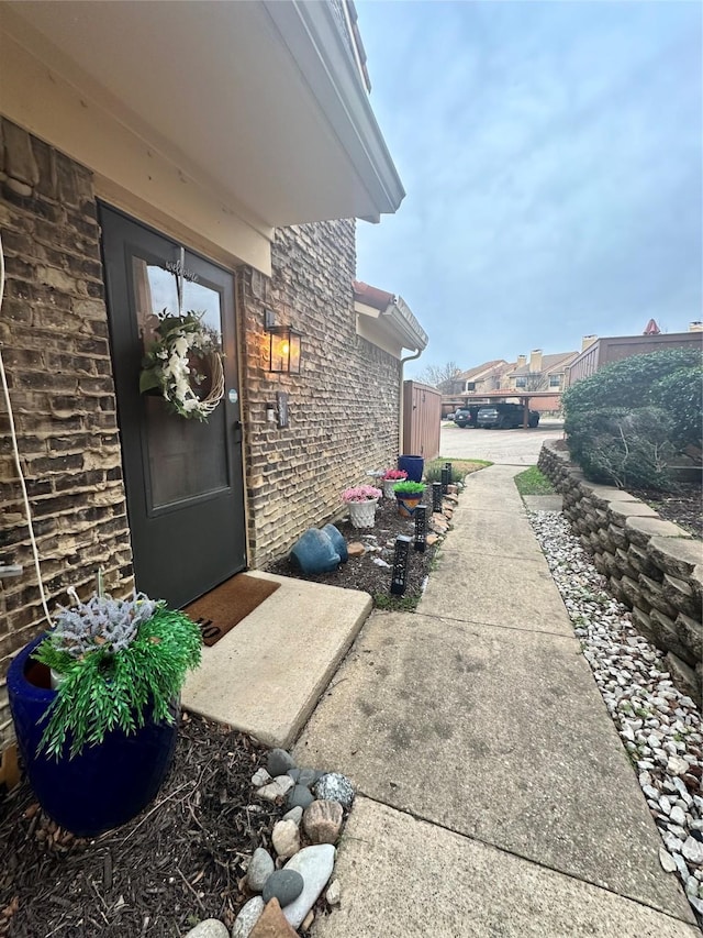 property entrance featuring brick siding