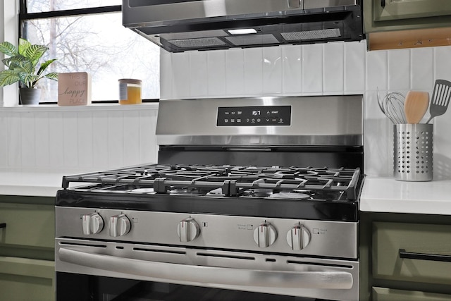 details featuring white cabinets, stainless steel gas range oven, and light countertops