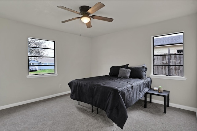 carpeted bedroom featuring ceiling fan and baseboards